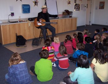 Terrence Farrell teaching school children about the guitar